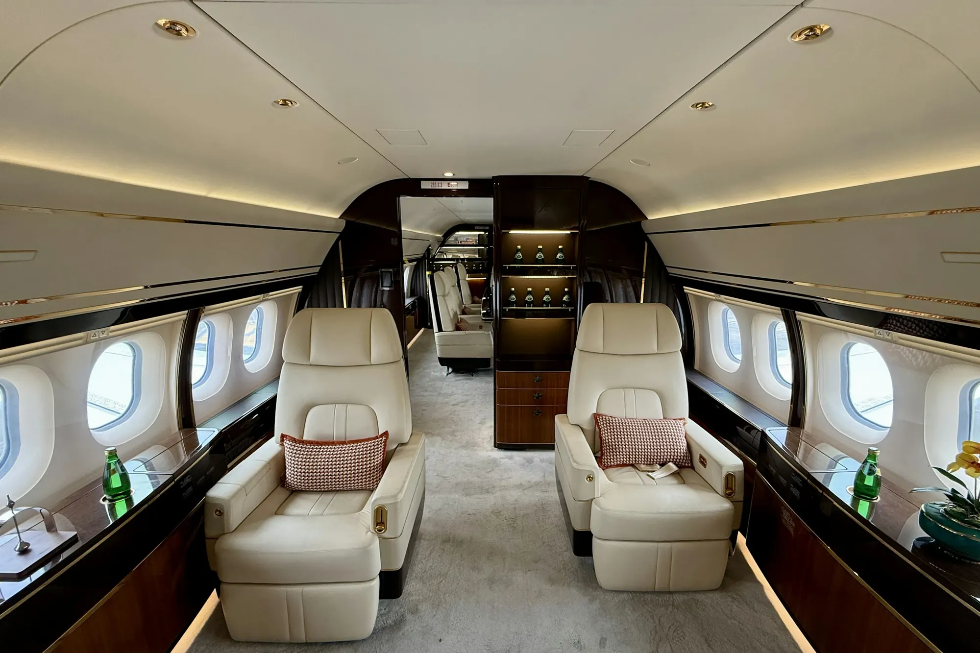 Cream leather seats facing each other in a wide business jet cabin