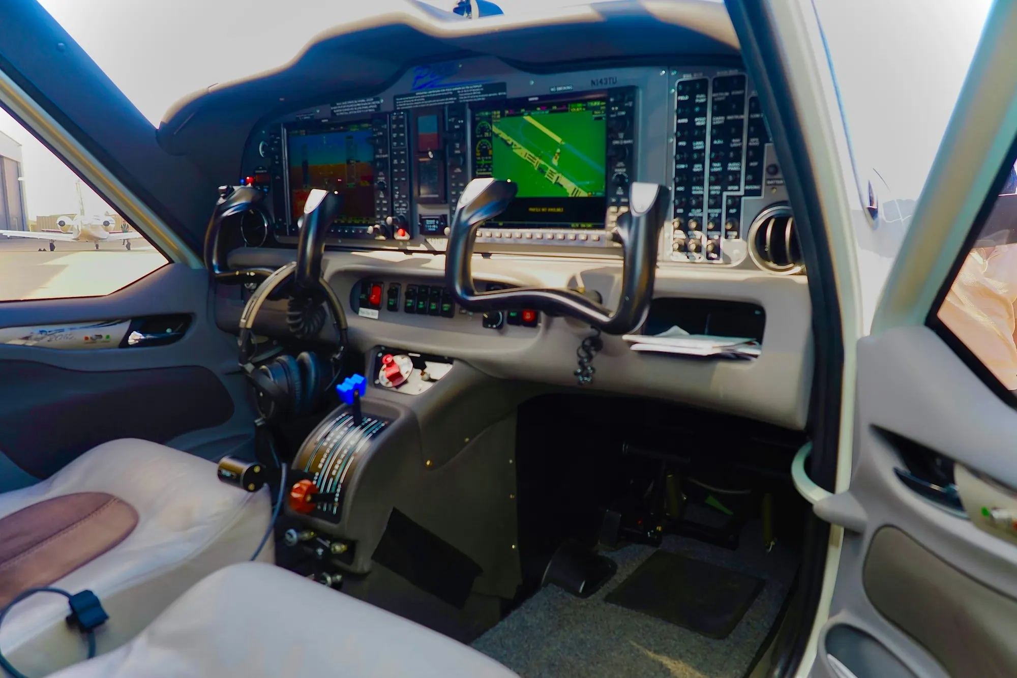 The glass cockpit of a single-pilot turboprop, seen from the cabin